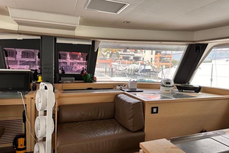 Interior of 2016 Fountaine Pajot Ipanema 58 catamaran with modern furnishings and large windows.