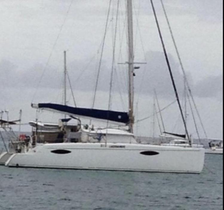 2009 Fountaine Pajot Orana 44 catamaran anchored on a cloudy day.