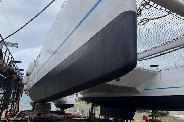 Etoile Marine Maxi Cat 24 catamaran, 2004 model, docked for maintenance.