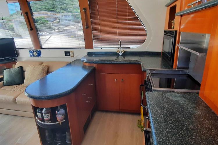 Luxurious kitchen interior of 2000 Carver 530 Voyager Pilothouse yacht with modern amenities.