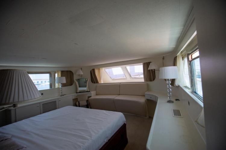 Luxurious interior of a 1972 Benetti 33 yacht, featuring elegant furnishings and ample natural light.