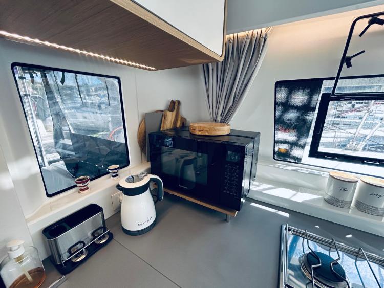 Modern kitchen in 2024 Excess 14 yacht with appliances and natural light.