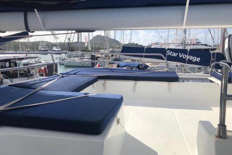 2017 Fountaine Pajot SABA 50 catamaran with blue seating, docked in a marina.