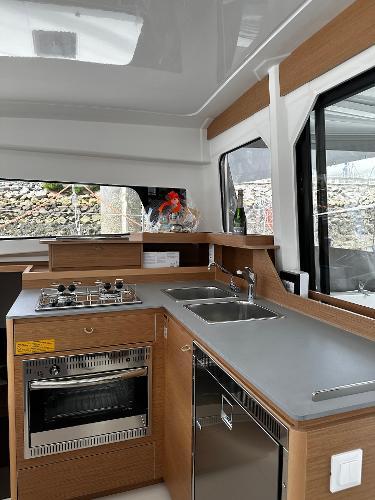 2024 Excess 11 yacht kitchen with modern appliances and sleek wood finish.