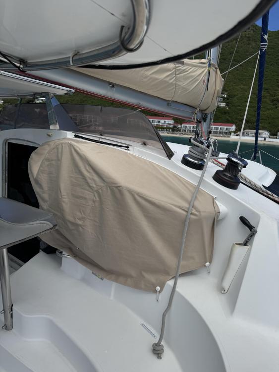 2006 Fountaine Pajot Bahia 46 yacht deck with covered equipment and scenic background.