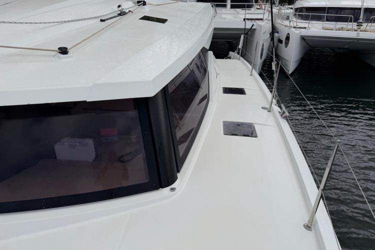2020 Fountaine Pajot Astrea 42 catamaran docked, showcasing sleek deck design and modern windows.