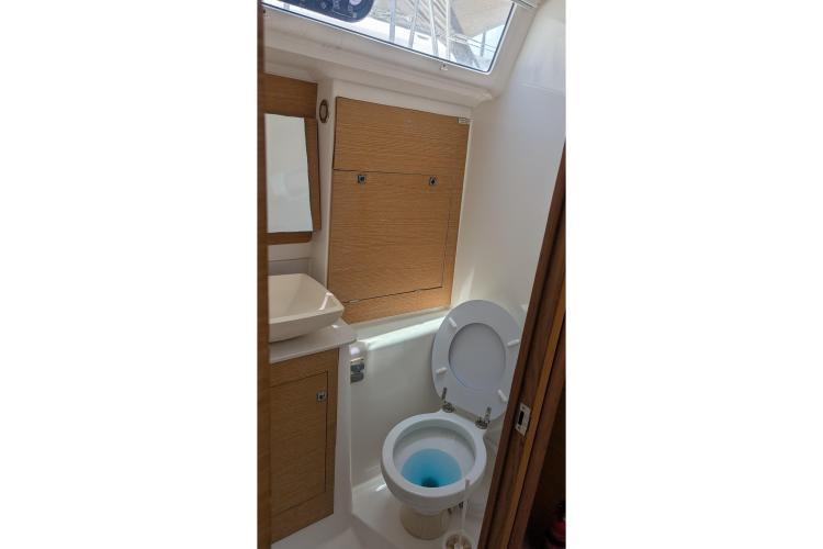Bathroom interior of 2017 Dufour 460 Grand Large yacht with wooden cabinetry.