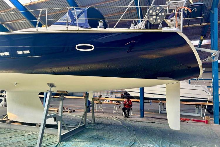 2006 Bavaria Cruiser 46 yacht in a boatyard, elevated for maintenance.