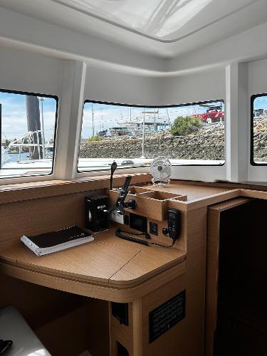 Interior of 2024 Excess 11 sailboat with navigation equipment and scenic window view.