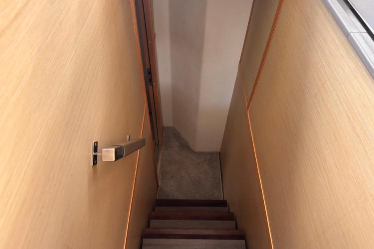 Staircase inside 2016 Fountaine Pajot Ipanema 58 yacht, featuring wooden walls and handrail.