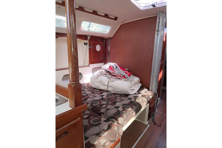 Interior of 1986 Dufour CATALINA sailboat with cozy cabin and patterned cushions.