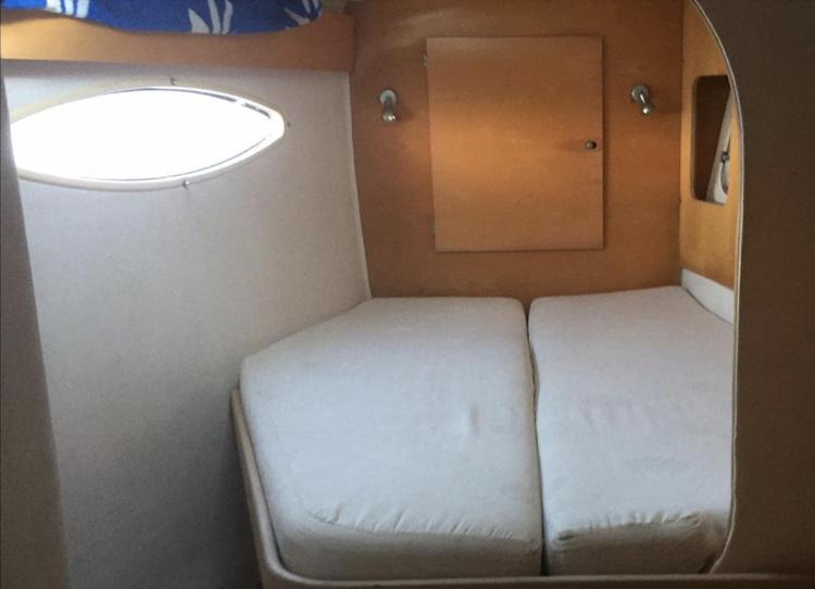 2009 Fountaine Pajot Orana 44 cabin interior with twin beds and porthole.