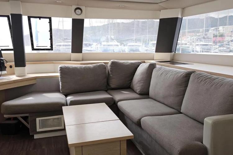 Luxurious interior of 2017 Fountaine Pajot SABA 50 catamaran with comfortable gray seating.
