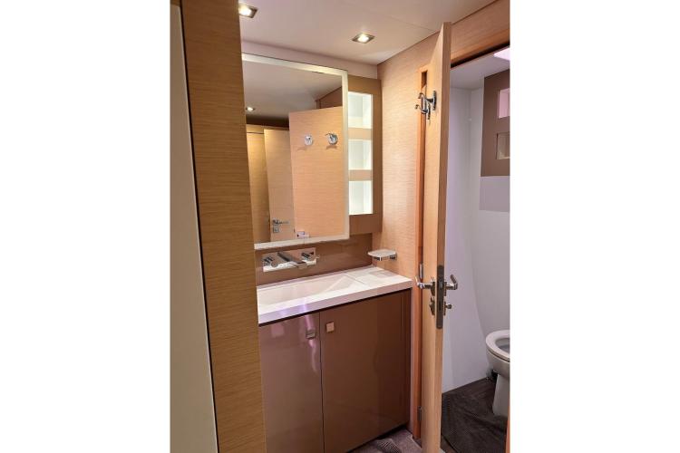 2016 Fountaine Pajot Ipanema 58 yacht bathroom with modern fixtures and wooden cabinetry.