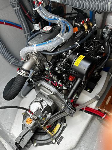 Engine compartment of a 2024 Excess 11 boat, showcasing detailed mechanical components.