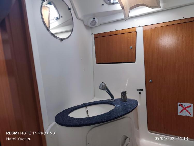 Bathroom interior of 2005 Beneteau Cyclades 43.3 yacht with sink and mirror.