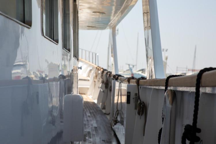 Side view of a 1972 Benetti 33 yacht, showcasing its sleek design and deck details.