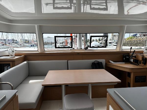 Interior of 2024 Excess 11 yacht with modern seating and large windows.