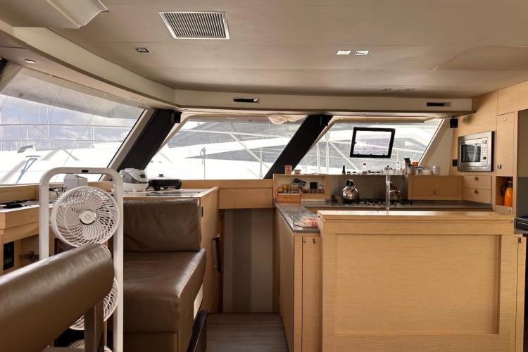 Interior of 2016 Fountaine Pajot Ipanema 58 yacht with modern kitchen and seating area.