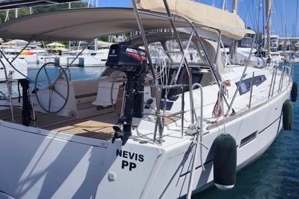 2017 Dufour 460 Grand Large yacht docked in marina, rear view.