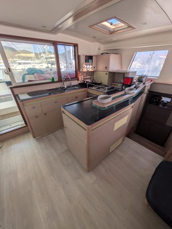 Spacious Catana 55 yacht kitchen interior with modern amenities and ample natural light, 2012 model.