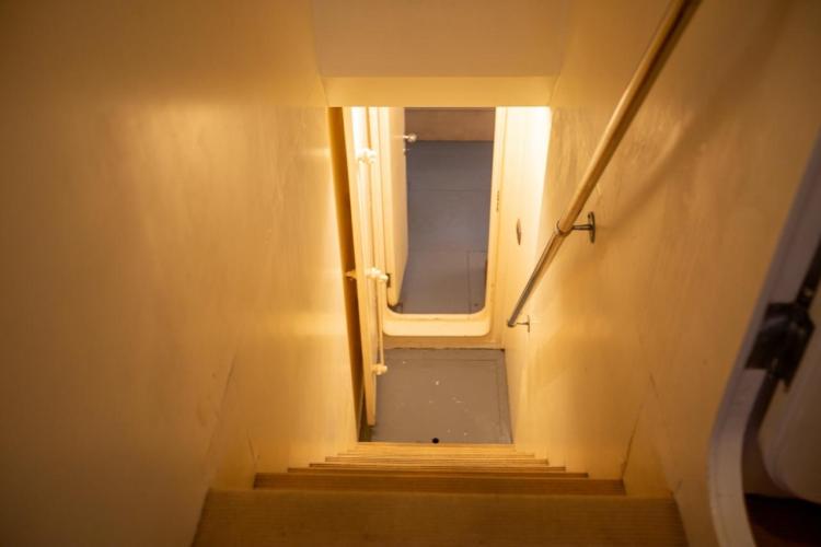 Staircase leading to lower deck on 1972 Benetti 33 yacht interior.