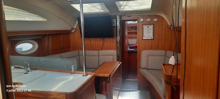 Interior of 2007 Elan Impression 434 yacht with wood paneling and seating area.