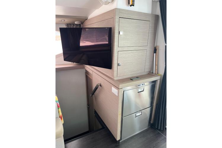 Interior of 2023 Fountaine Pajot Astrea 42 Catamaran with TV and storage cabinets.
