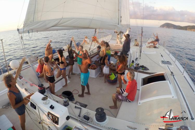 People enjoying a party on a 1995 Catamaran Day Charter Open Bridge Deck.