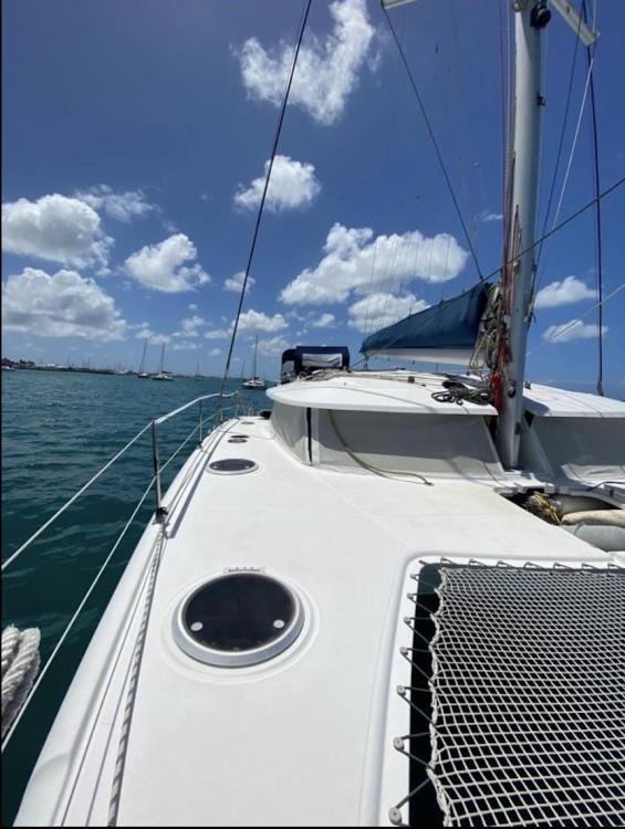 2009 Fountaine Pajot Orana 44 catamaran sailing on a sunny day with clear skies.