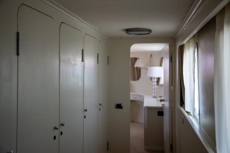 Interior hallway of a 1972 Benetti 33 yacht, featuring elegant cabinetry and soft lighting.