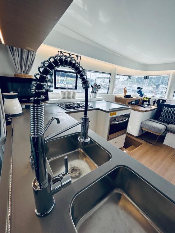 Modern kitchen interior of 2024 Excess 14 yacht with sleek fixtures and ample natural light.