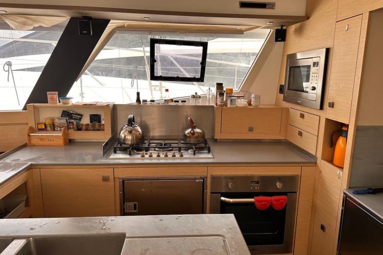 Modern kitchen interior on 2016 Fountaine Pajot Ipanema 58 yacht, featuring appliances and storage.