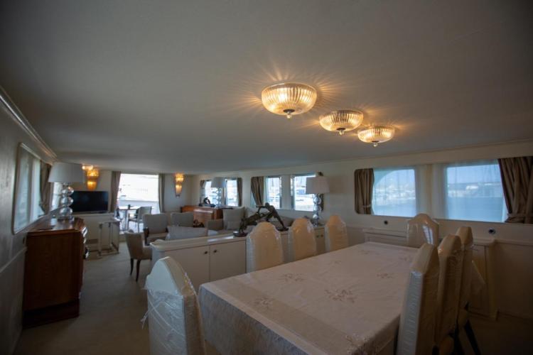 Luxurious interior of 1972 Benetti 33 yacht with elegant dining and seating area.