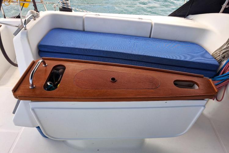 Beneteau Cyclades 43.3 cockpit with wooden table and blue cushion, 2005 model.