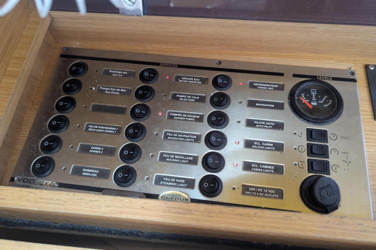 Control panel of a 2017 Dufour 460 Grand Large yacht, featuring various switches and gauges.