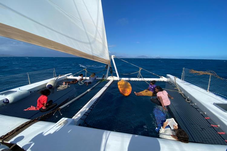 People relaxing on Etoile Marine NAUTILUS 360 catamaran, sailing on a sunny day, 2004 model.