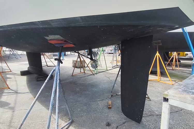Jeanneau Sun Odyssey 37 sailboat under maintenance, showing keel and supports, 2000 model.