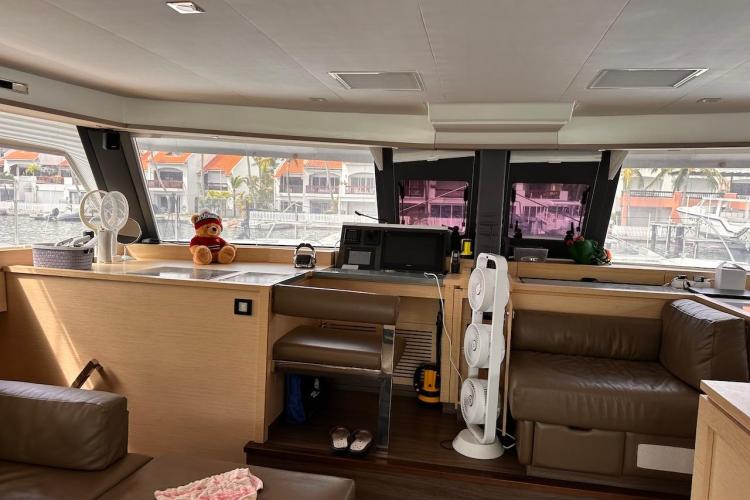 Interior of 2016 Fountaine Pajot Ipanema 58 yacht with plush seating and panoramic windows.