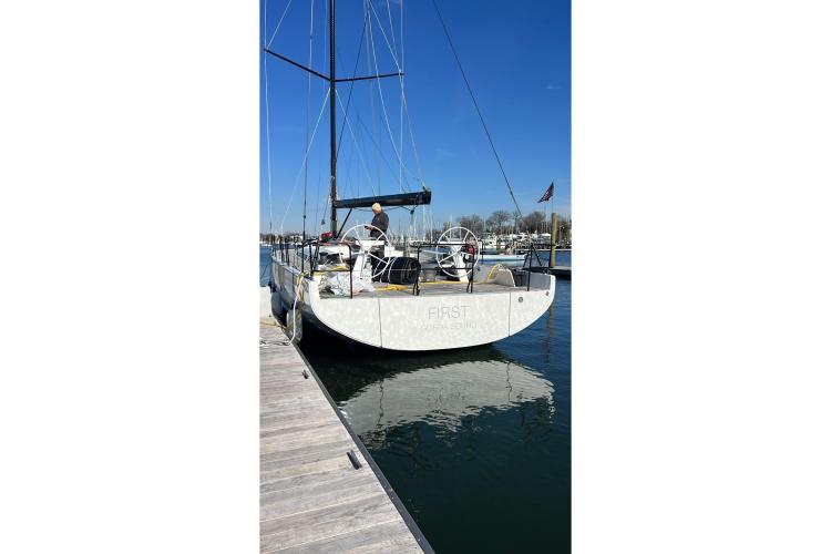 2024 Beneteau First 53 yacht docked at marina under clear blue sky.