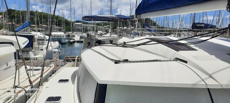 2017 Fountaine Pajot SABA 50 catamaran docked in a marina, surrounded by other boats.