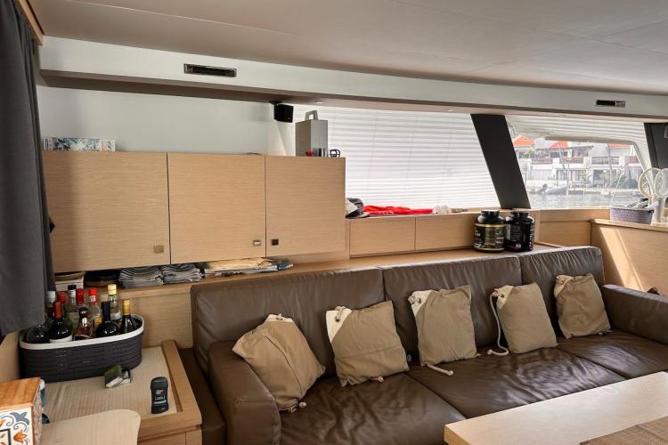 Interior of 2016 Fountaine Pajot Ipanema 58 yacht with leather seating and wooden cabinetry.