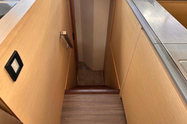 Interior stairs of 2016 Fountaine Pajot Ipanema 58 yacht, featuring wooden finish.