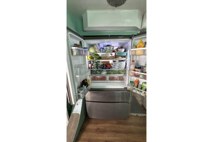 Open refrigerator filled with various food items, inside a 2004 Etoile Marine Maxi Cat 24.
