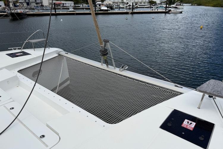 2020 Fountaine Pajot Astrea 42 catamaran with netting, docked in a marina.