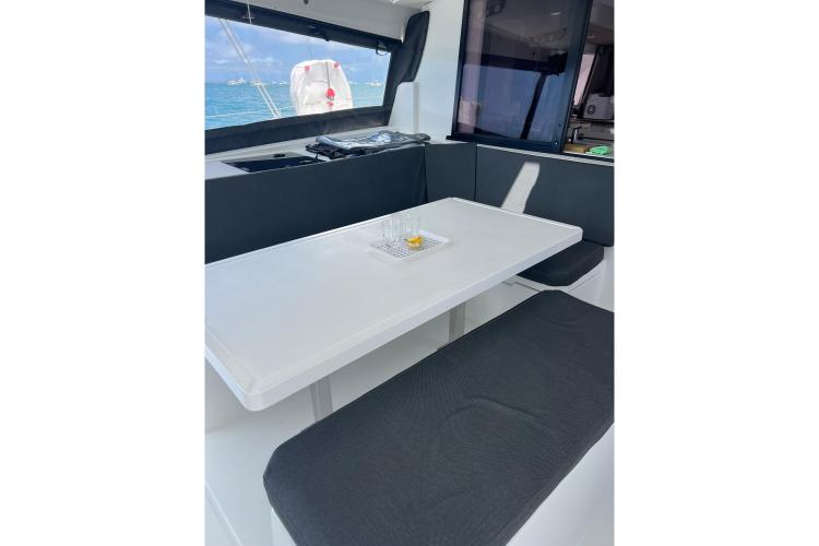 Interior of 2023 Fountaine Pajot Astrea 42 Catamaran with dining area and ocean view.
